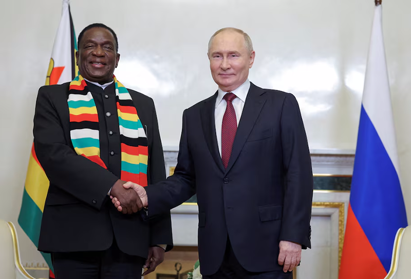 Russia's President Vladimir Putin shakes hands with Zimbabwe's President Emmerson Mnangagwa