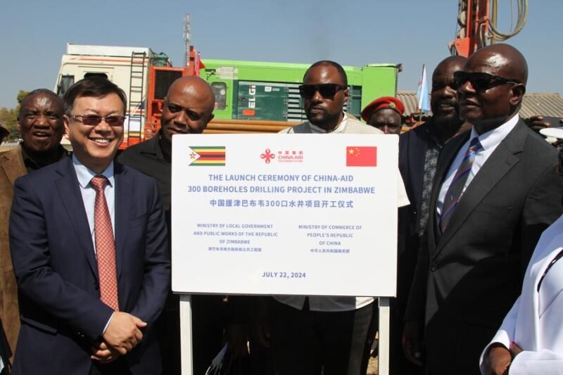 Chinese Ambassador to Zimbabwe Zhou Ding poses for photos with Zimbabwean officials at the launch ceremony of a China-aided borehole drilling project in Mahusekwa, a town in Mashonaland East Province