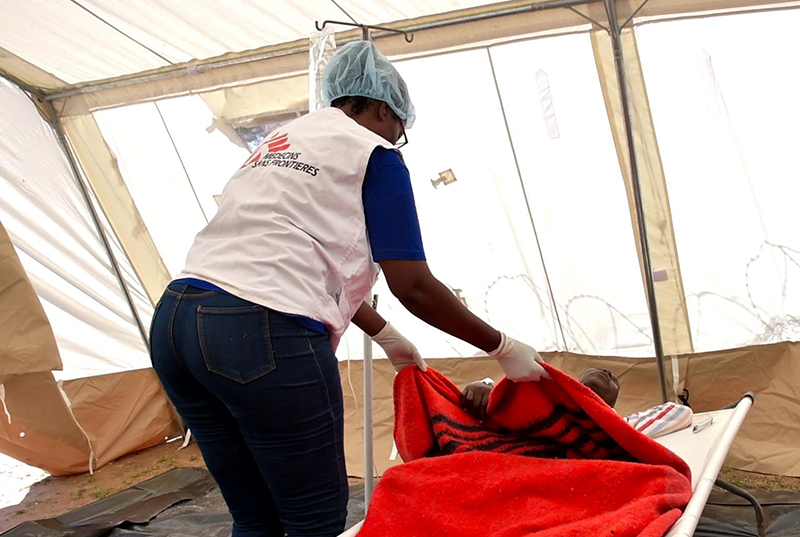 MSF nurse checking up on Cholera patient in a CTU at Zangama Clinic