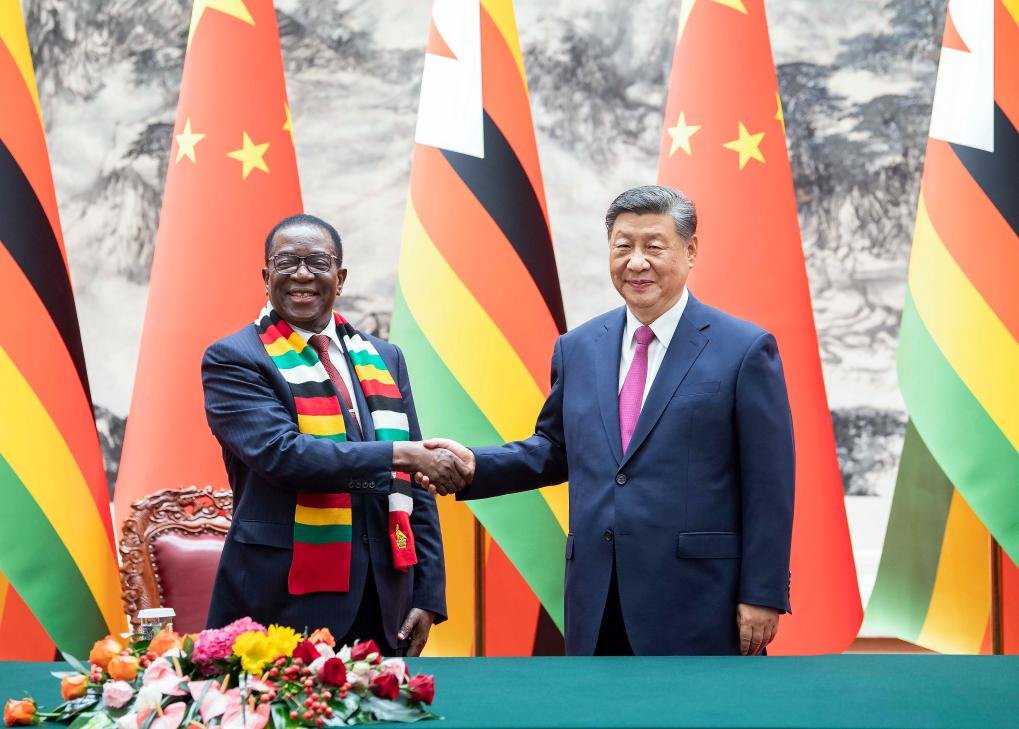 Chinese President Xi Jinping and Zimbabwean President Emmerson Mnangagwa witness the signing of cooperation documents after their talks at the Great Hall of the People in Beijing