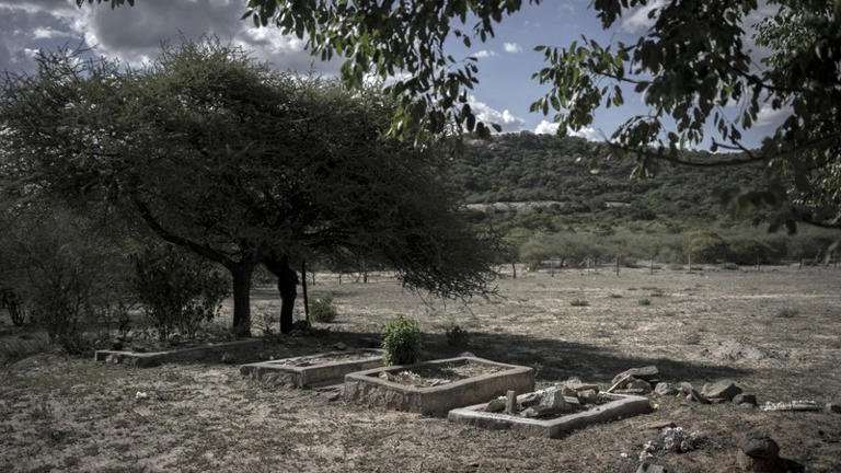 Graves are seen on December 20, 2017 at a monument built at the site of disused Bhalagwe barracks in Matabeleland South province