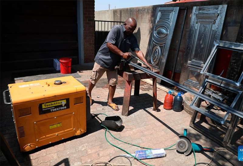 Zimbabwean welder Ngwarayi Mushaurwa works at home using a diesel generator in Harare