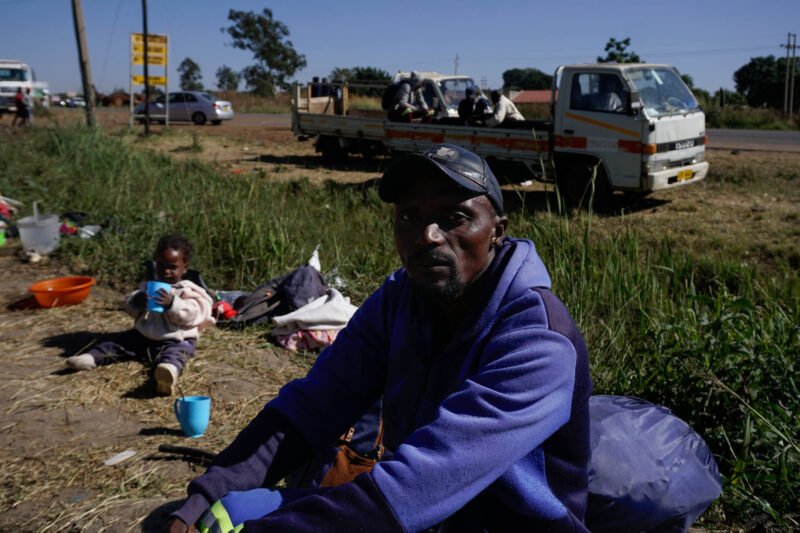 Gift Ngoma, a tobacco farmer, waits to sell his crop in Harare. He turned to farming after losing his formal job, but he says contract agreements have trapped him in debt. He now advocates for land rights and alternative financing.