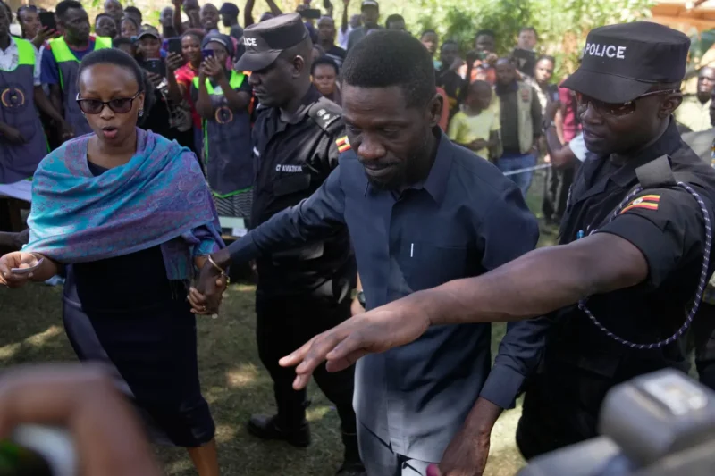 Uganda opposition presidential candidate Robert Kyagulanyi Ssentamu, famously known as Bobi Wine of the National Unity Platform (NUP), arrives with his wife to cast their votes, during the presidential election at a polling station, in Kampala