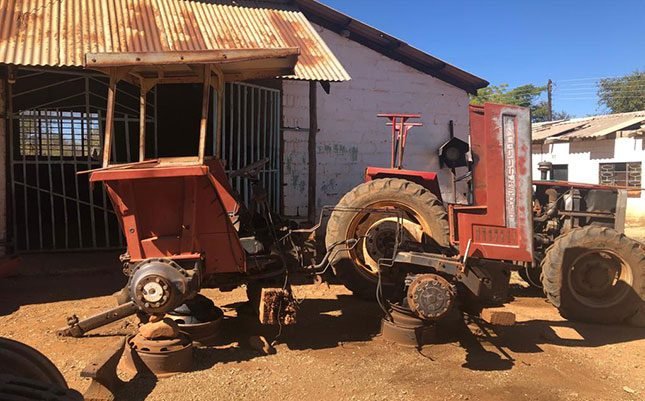 An old tractor in front of a farm workshop on Portwe Farm in Zimbabwe, formerly owned by Dave Joubert.