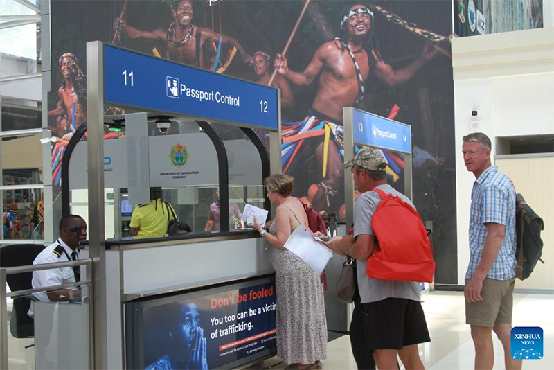 People go through passport control at Robert Gabriel Mugabe International Airport in Harare, Zimbabwe, on March 5, 2026